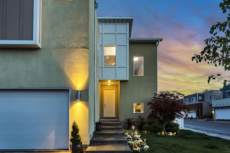Residential exterior with warm windows at dusk